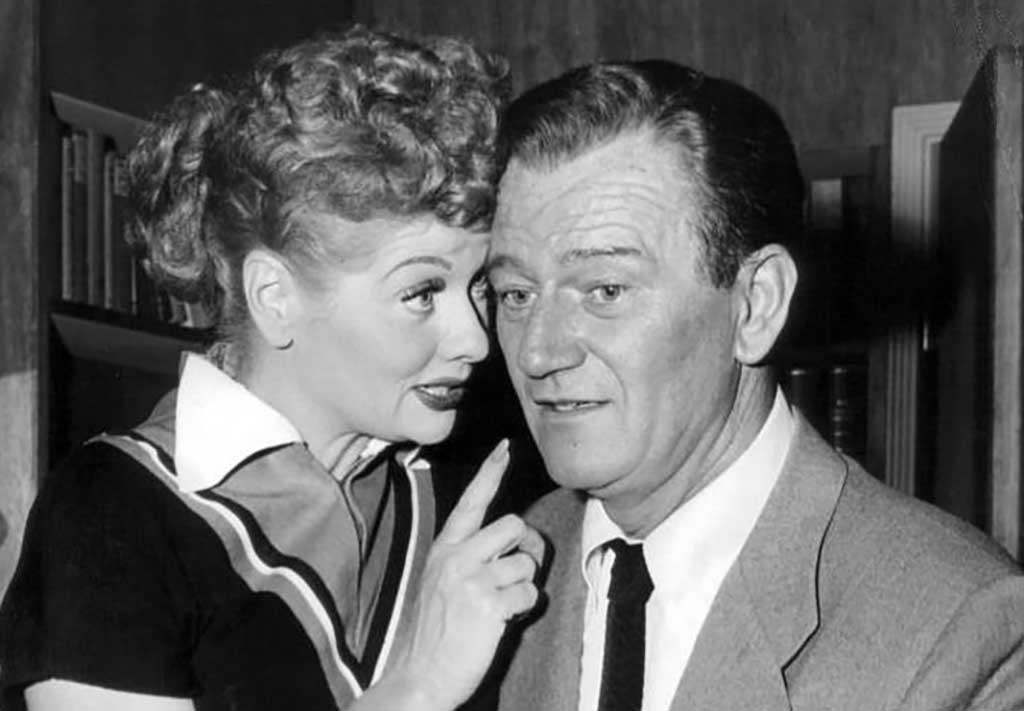 Lucille Ball pitches a show idea to John Wayne (1955). Wikimedia Commons public domain image